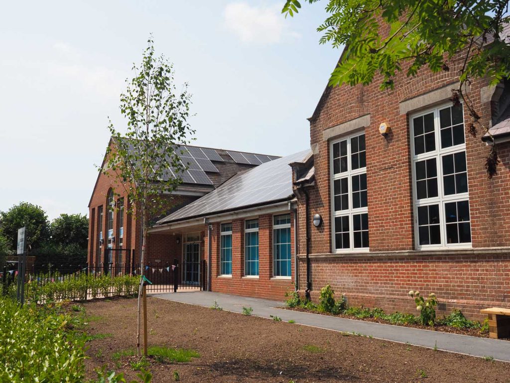 Newly fitted solar panels on the roof of an old school building